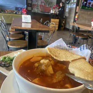 Menudo (18.95) housemade corn tortillas on edge.