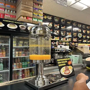 a man sitting at a counter with a beverage dispenser