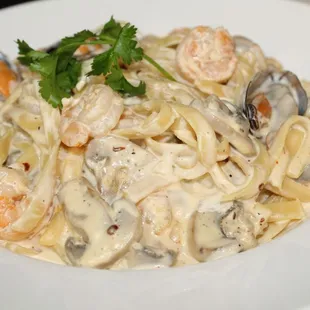 a plate of pasta with shrimp and clams