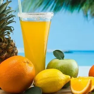 a pineapple, oranges, lemons, and limes