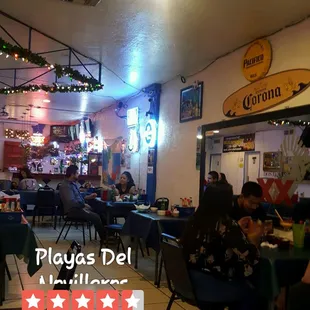 people sitting at tables in a restaurant