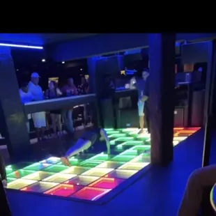 a woman doing pushups on the dance floor