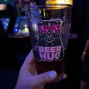 a person holding a beer glass