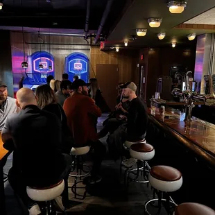 a group of people sitting at the bar