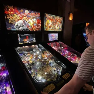a man playing a pinball game