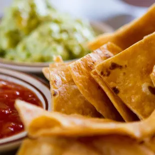 Homemade tortilla chips served with fresh guacamole and salsa