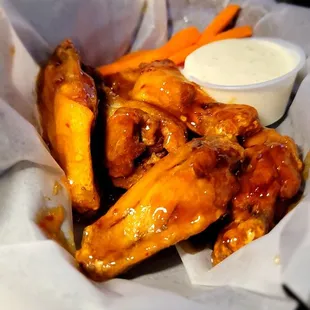 a basket of wings and carrots
