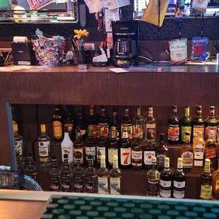 a pool table with a billiards table in the background