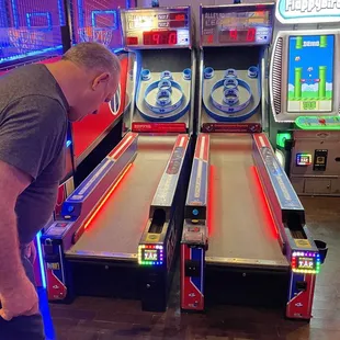 a man playing a game of pinball