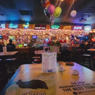 a table with a menu and balloons