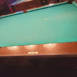 a pool table with a green cloth
