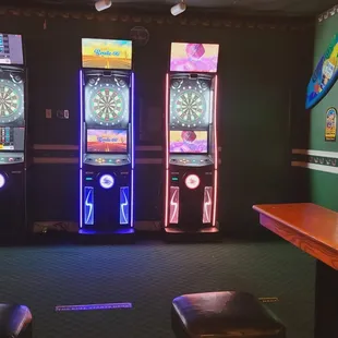 a row of slot machines with neon lights