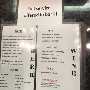 Small, obscured sign where one orders &amp; pays before a take-out or after they've eaten in the bar.