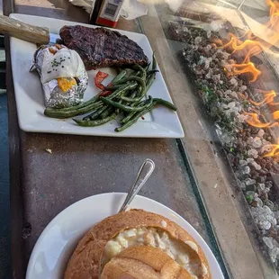 Steak with baked potatoe and green beans Clam chowder bowl