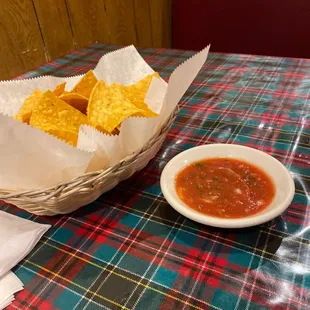 a bowl of chips and a bowl of salsa