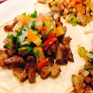 Close up of carne asada tacos with pico de gallo