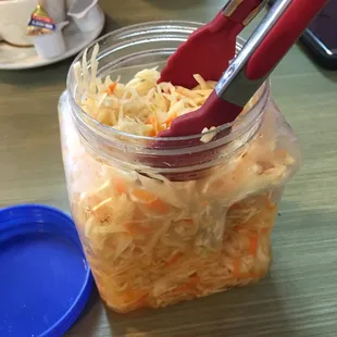 a jar of sauerkraut on a table