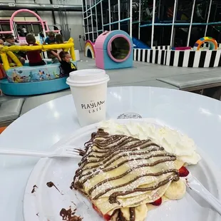 Crepe with banana, strawberry nougat drizzle and whipped cream.