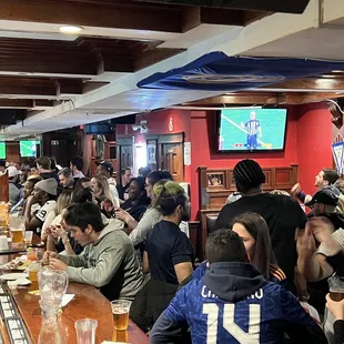 a large group of people sitting at a bar