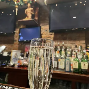 a glass of champagne on a bar