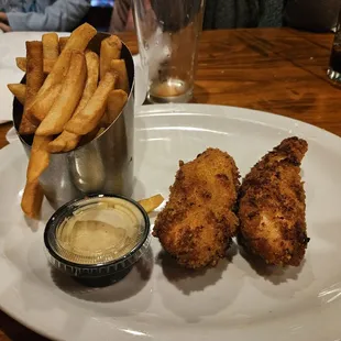 a plate of fried chicken nuggies and fries