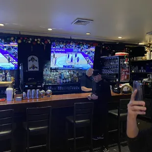 a man taking a picture of the bar