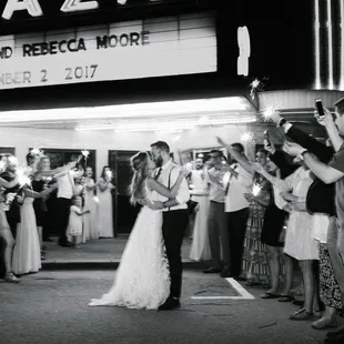 a bride and groom holding sparklers