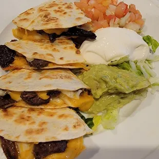 quesadillas, lettuce, tomatoes, and sour cream