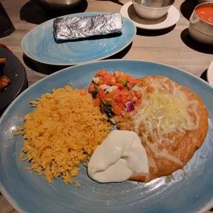 Rice, beans, sour cream, and pico de Gallo. Flour tortillas inside of foil pack.