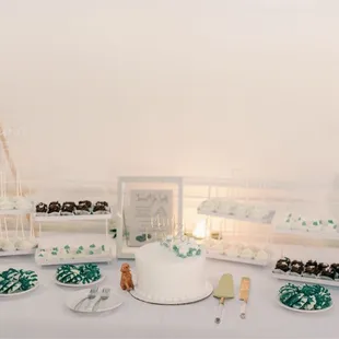 a table with a cake and desserts