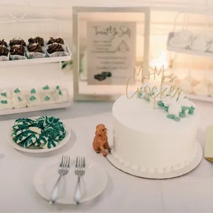 a table with a cake and desserts
