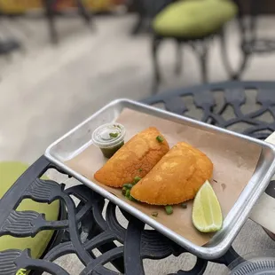 two fried fish fillets on a tray
