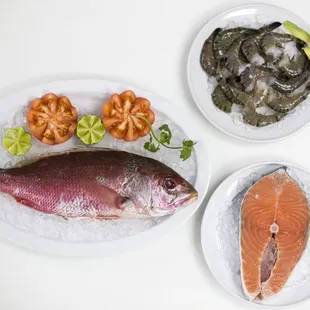 two plates of fish and vegetables