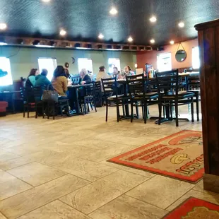 people sitting at tables in a restaurant