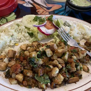 Chunks of tasty tilapia with tomatoes, peppers, and cilantro