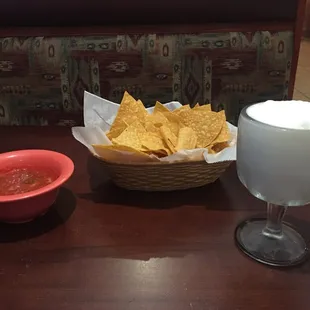 a bowl of chips and a glass of water