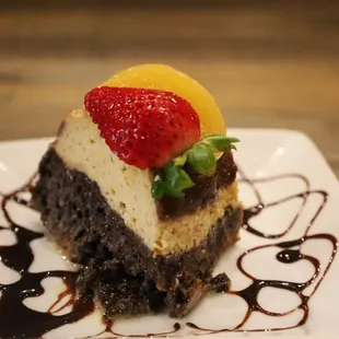 a piece of chocolate cake with a strawberry on top