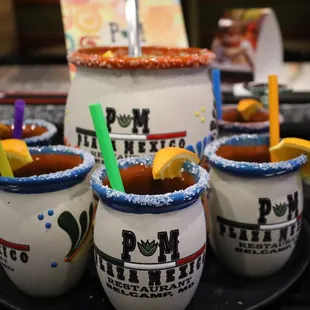 a close up of three mugs with drinks in them