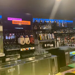 a bar with a variety of drinks