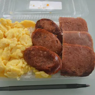 Breakfast Bento.  Perfect scrambled eggs, portuguese sausage, and spam, on a bed of rice. Under $5.
