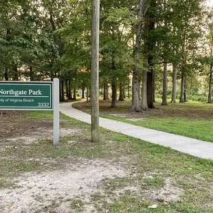 View of the wooded area and paved walking path that connects to an adjoining neighborhood