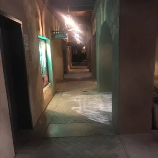 an empty hallway with lights on