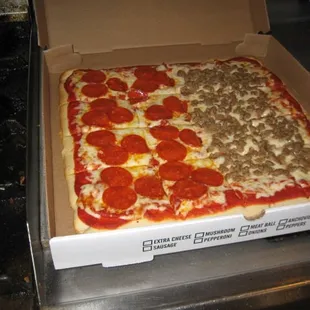 a pepperoni pizza in a pizza box