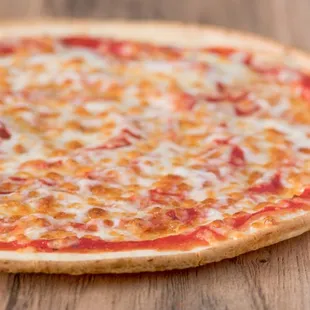 a cheese pizza on a wooden table