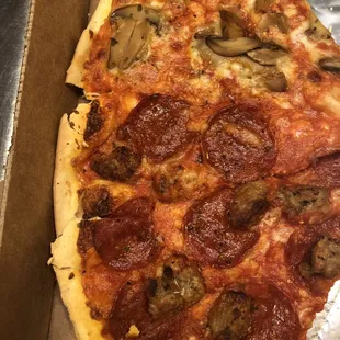 Half and half pizza (yes, a few pieces were eaten before this photo was taken). Had to show the mushroom half that's missing the sausage.