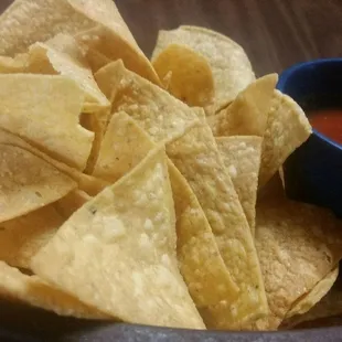a bowl of chips and a bowl of salsa