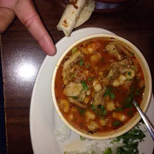 a bowl of soup and a tortilla