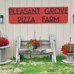 a sign for pleasant grove pizza farm