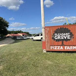 a sign for pleasant grove pizza farm