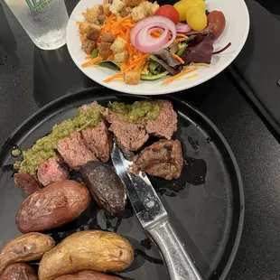 Flank steak with potatoes (they forgot to season them!) and side salad